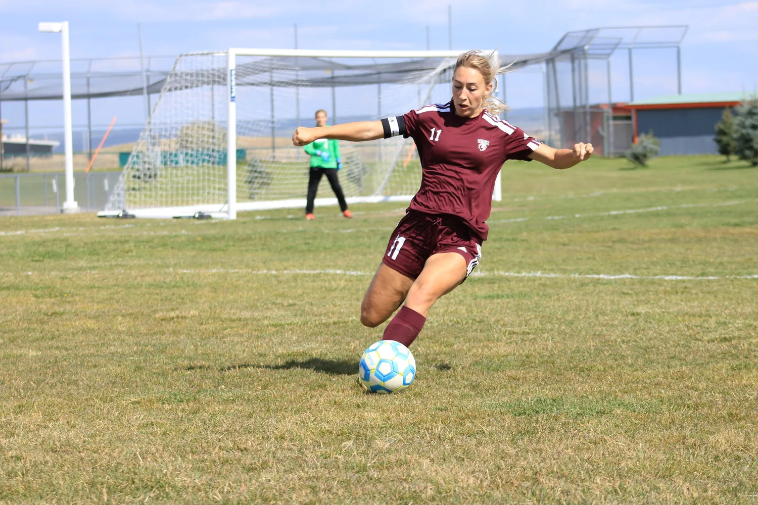 Girls' soccer player winding up for a kick