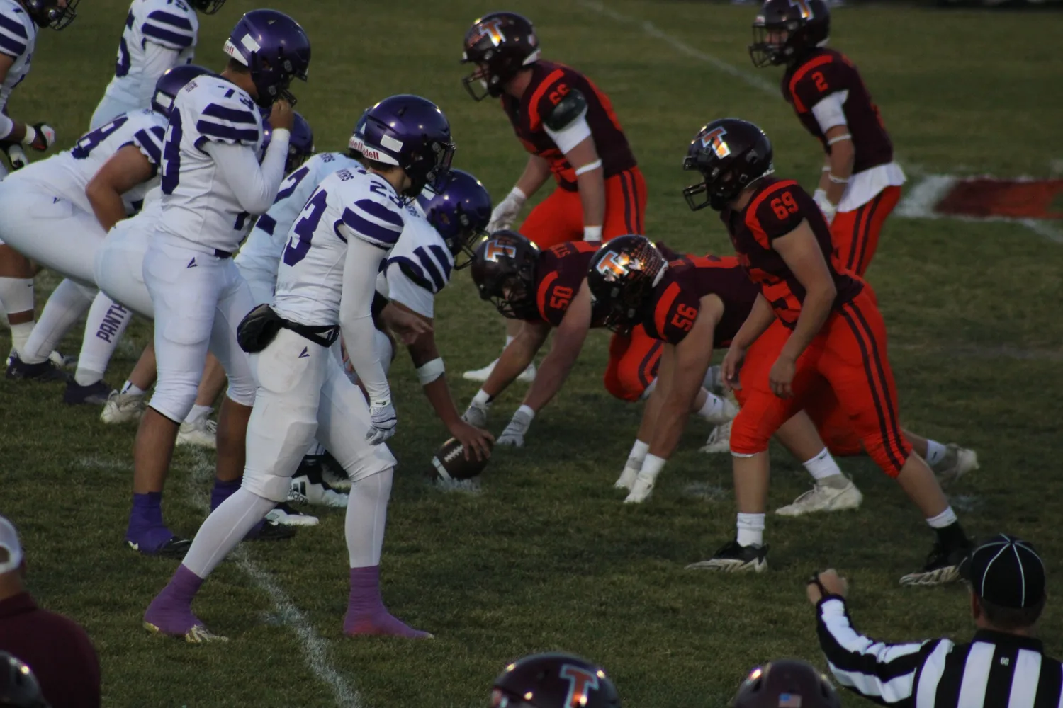High school football linemen set at the line of scrimmage