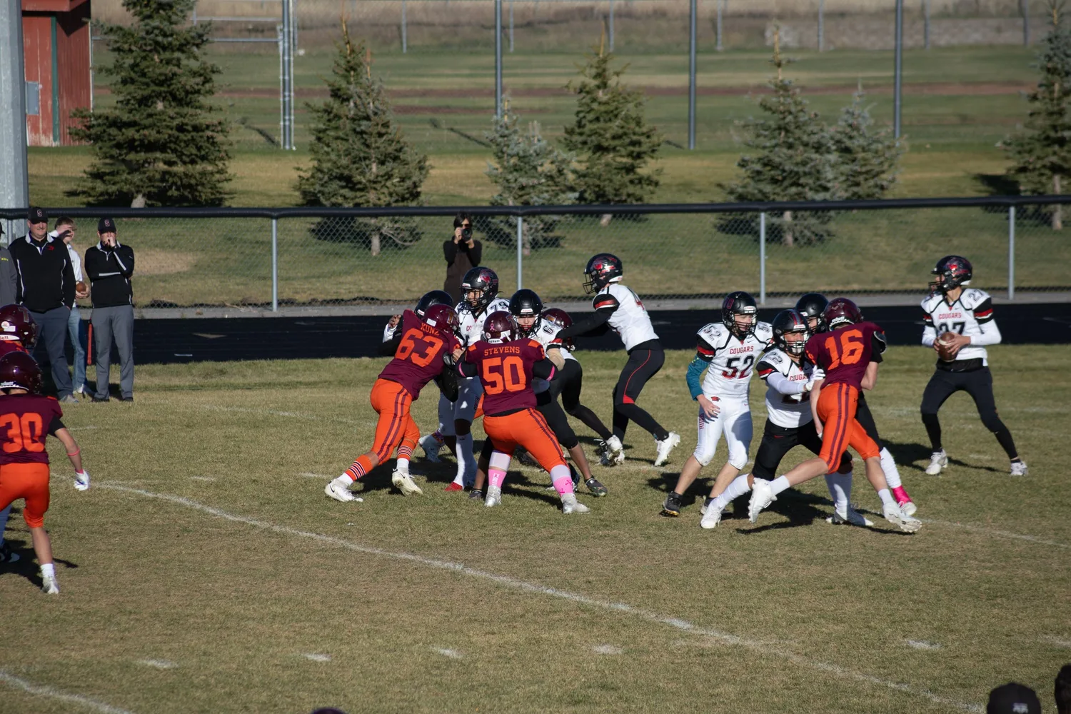Youth football teams colliding at the line of scrimmage