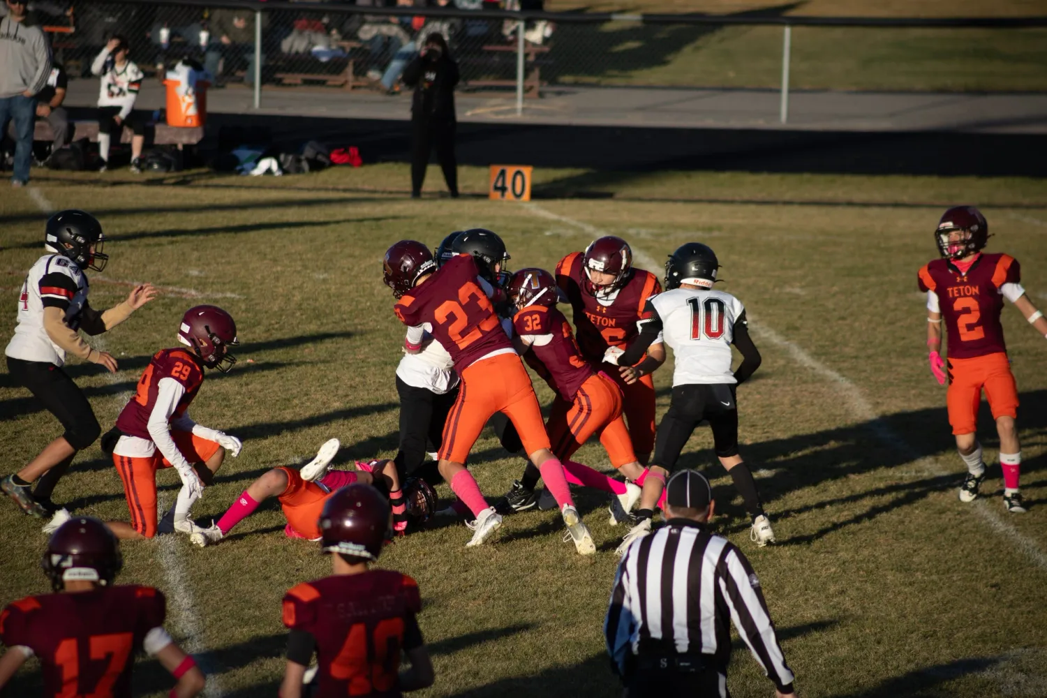 Youth football players piling up after a tackle
