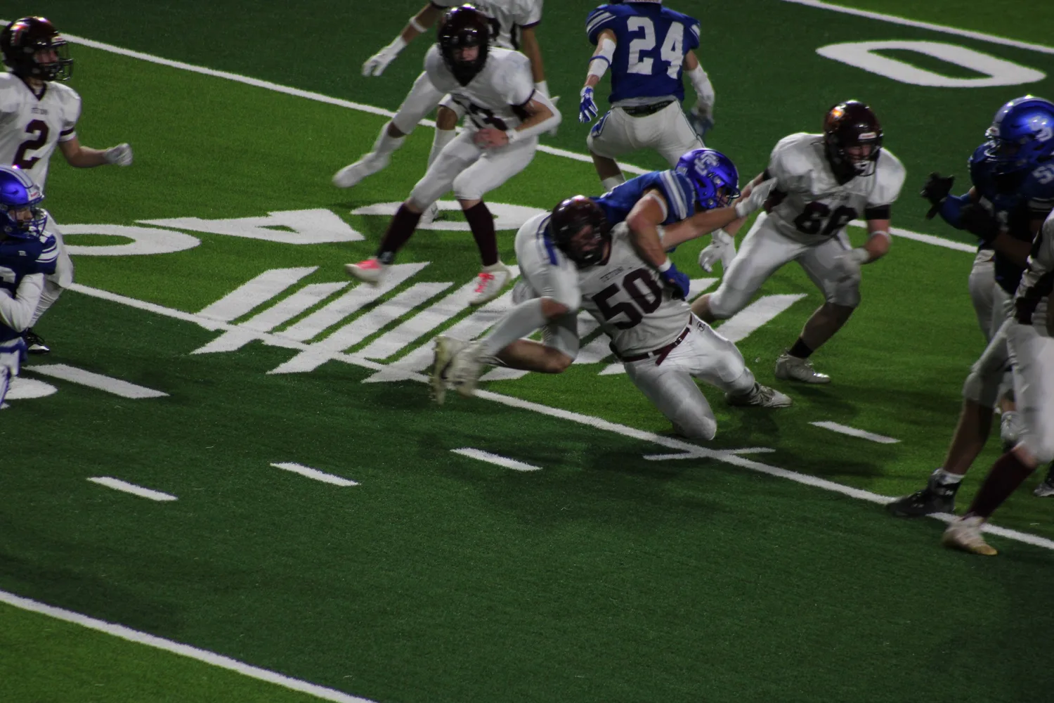 Football players diving toward the goal line during a game
