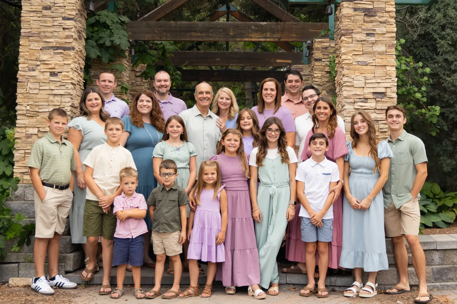 Large multigenerational family under a stone and timber pavilion
